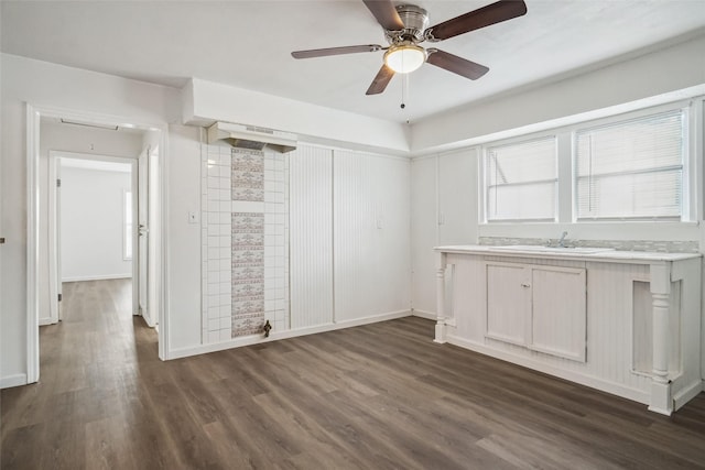 interior space featuring dark hardwood / wood-style flooring, sink, and ceiling fan