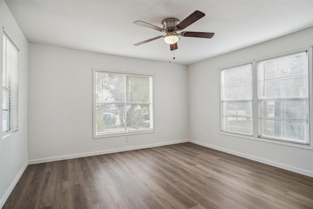 spare room with dark hardwood / wood-style floors and ceiling fan