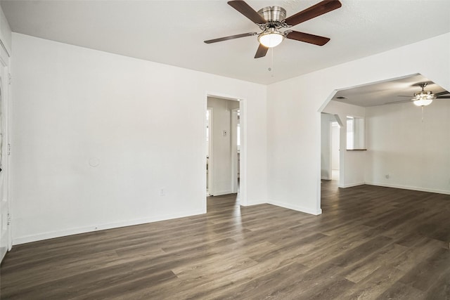 spare room with dark hardwood / wood-style floors and ceiling fan