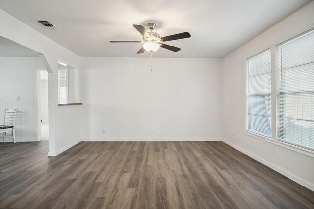 empty room featuring ceiling fan and dark hardwood / wood-style floors