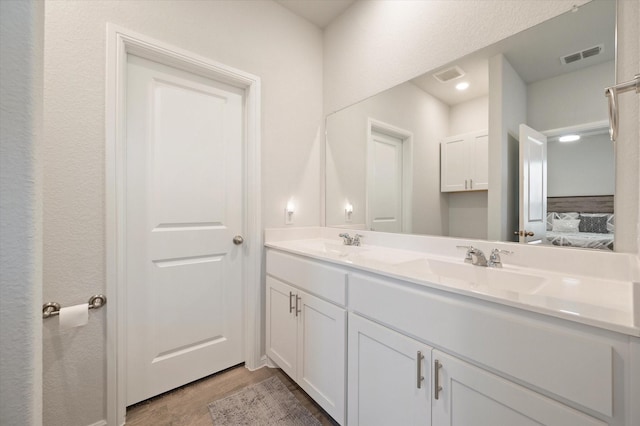 bathroom with vanity and wood-type flooring