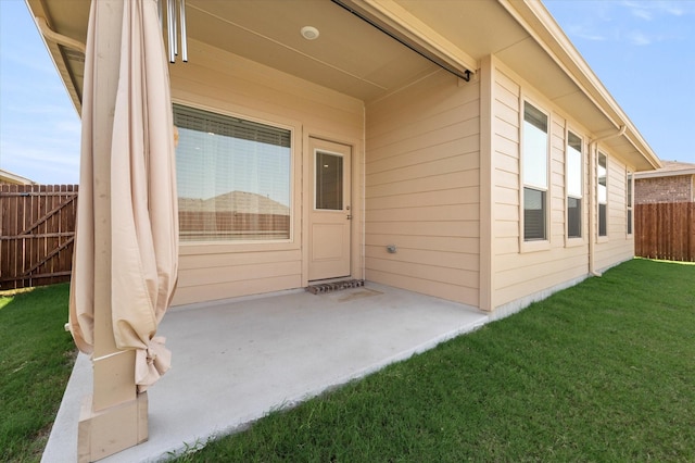 doorway to property featuring a yard and a patio area