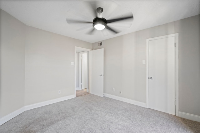 unfurnished bedroom with light colored carpet and ceiling fan