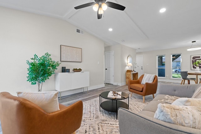 living room with vaulted ceiling, ceiling fan, and light hardwood / wood-style flooring