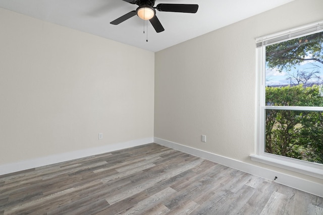 empty room with ceiling fan and hardwood / wood-style floors