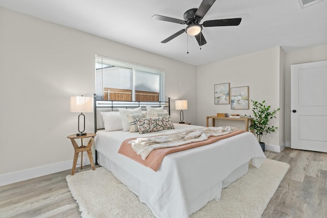 bedroom with ceiling fan and light wood-type flooring