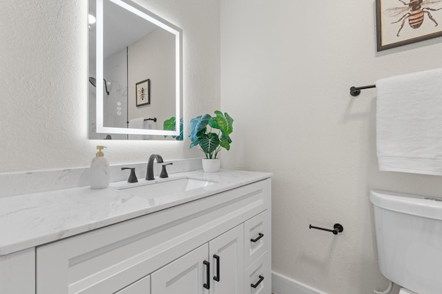 bathroom with vanity and toilet