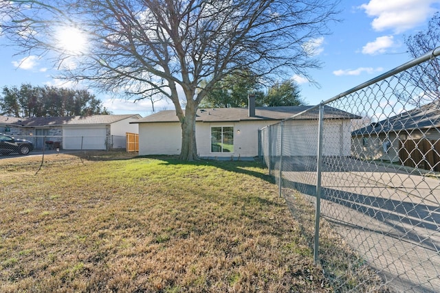 back of house featuring a yard