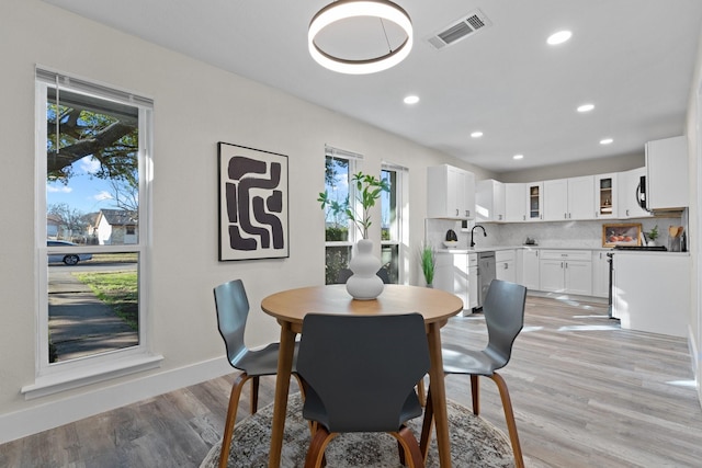 dining area with light hardwood / wood-style floors