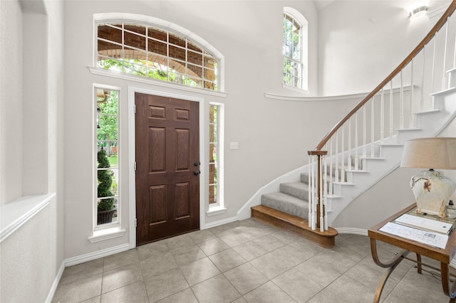 1417 Flying Jib Dr, Azle, TX 76020 - tiled entrance foyer with stairs, a towering ceiling, and baseboards