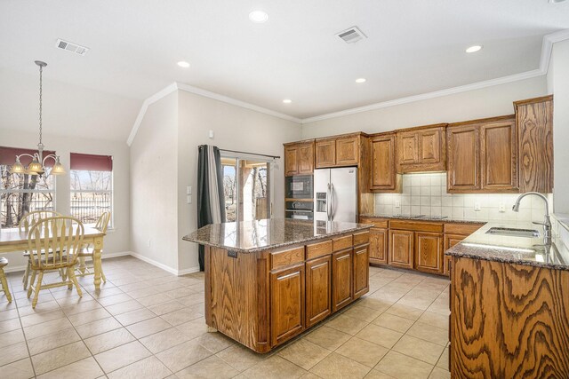 tiled dining area with crown molding and a chandelier