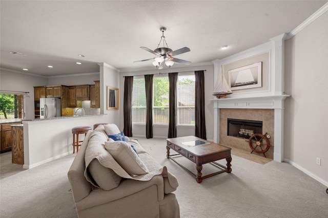 1417 Flying Jib Dr, Azle, TX 76020 - living area with light carpet, crown molding, a tile fireplace, plenty of natural light, and ceiling fan