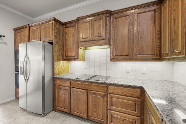 1417 Flying Jib Dr, Azle, TX 76020 - kitchen featuring black appliances, brown cabinetry, crown molding, light stone countertops, and light tile patterned floors