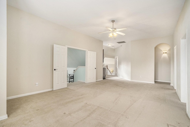 carpeted empty room featuring ceiling fan