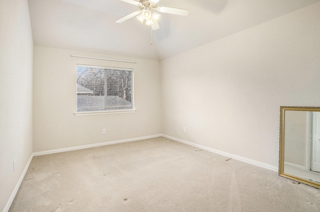 carpeted empty room with vaulted ceiling and ceiling fan