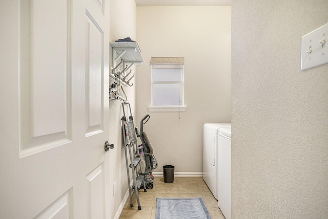 laundry area with separate washer and dryer and light tile patterned floors