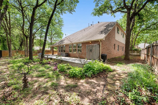 1417 Flying Jib Dr, Azle, TX 76020 - rear view of house with brick siding, a wooden deck, a fenced backyard, and a shingled roof