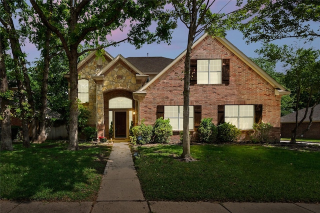 1417 Flying Jib Dr, Azle, TX 76020 - traditional-style house featuring a yard, brick siding, and stone siding