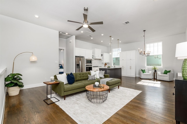 living room featuring sink, ceiling fan with notable chandelier, and dark hardwood / wood-style floors