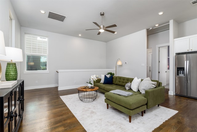 living room with ceiling fan and dark hardwood / wood-style floors