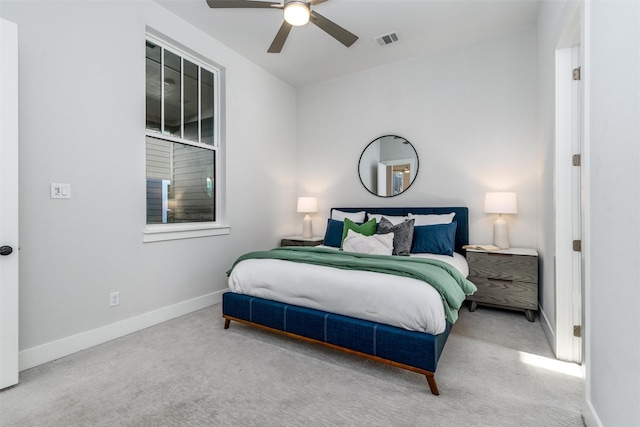 bedroom featuring light colored carpet and ceiling fan