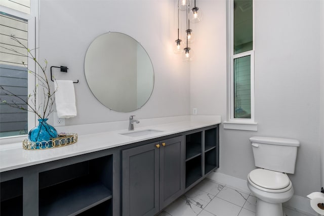 bathroom featuring vanity and toilet