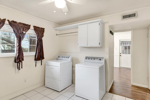 laundry area featuring cabinets, ornamental molding, ceiling fan, and washer and clothes dryer