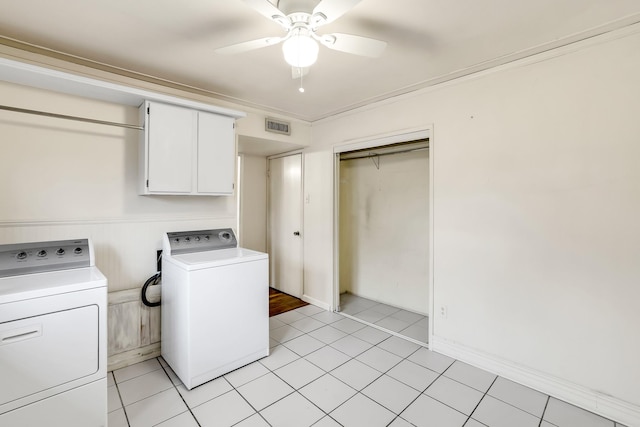 washroom with light tile patterned flooring, washer and dryer, cabinets, ornamental molding, and ceiling fan