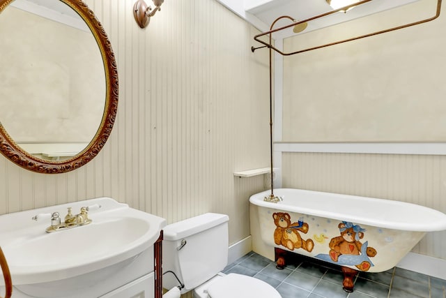 bathroom with toilet, tile patterned flooring, sink, and a tub