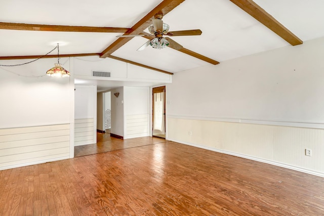 spare room with lofted ceiling with beams, ceiling fan, and hardwood / wood-style floors