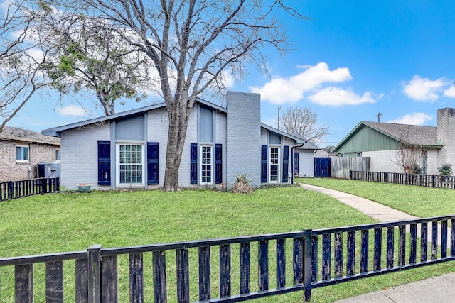 view of side of property with a lawn