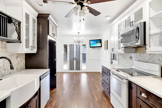 kitchen featuring white cabinetry, appliances with stainless steel finishes, sink, and dark brown cabinetry