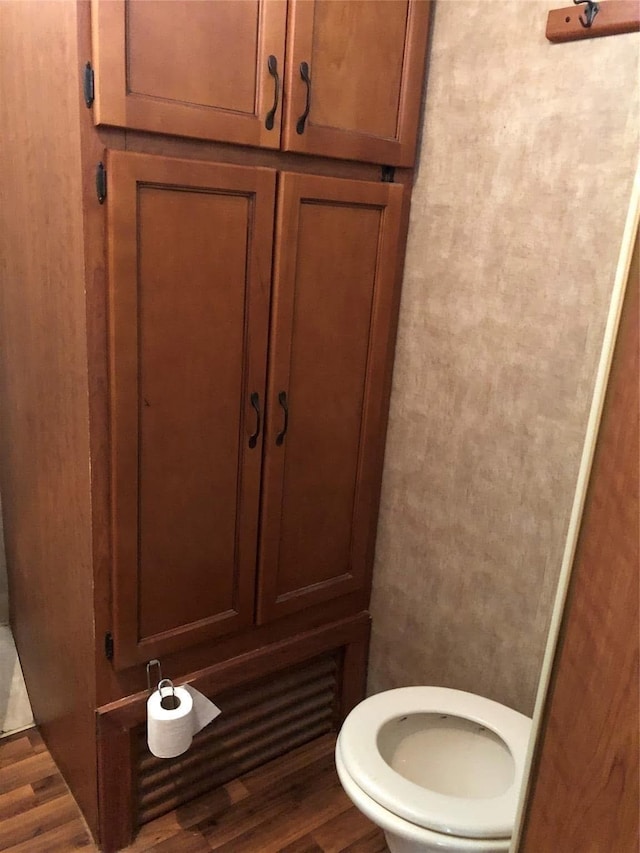 bathroom featuring hardwood / wood-style flooring and toilet