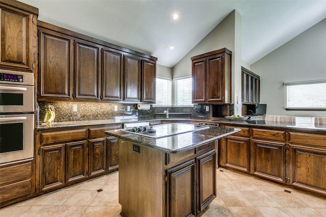 kitchen featuring lofted ceiling, double oven, black electric cooktop, and a kitchen island