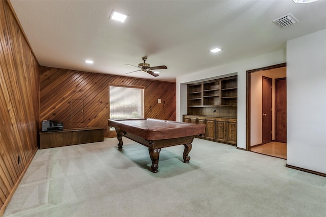 rec room with pool table, light colored carpet, ceiling fan, and wood walls