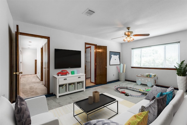 carpeted living room featuring ceiling fan