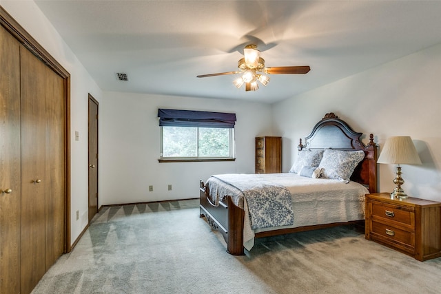 carpeted bedroom featuring ceiling fan and a closet