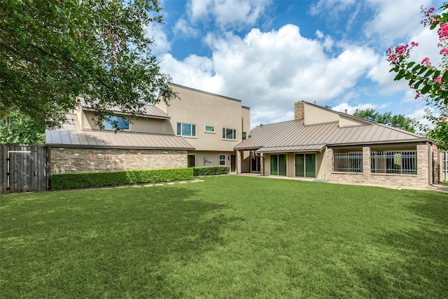 rear view of property with a yard