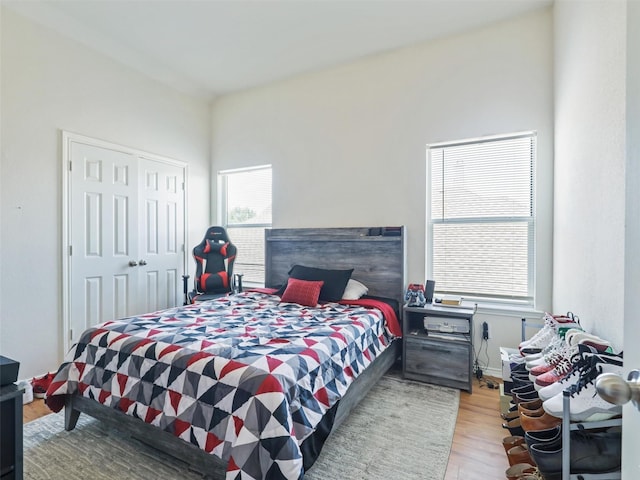 bedroom with light hardwood / wood-style flooring and a closet