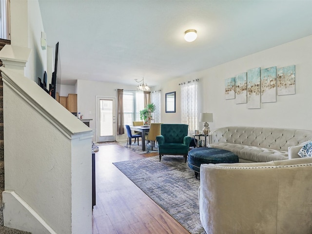 living room featuring light hardwood / wood-style floors and a chandelier