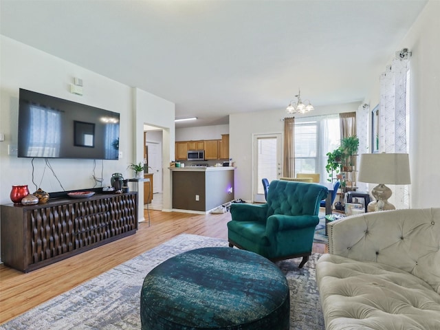 living room featuring an inviting chandelier and light hardwood / wood-style floors