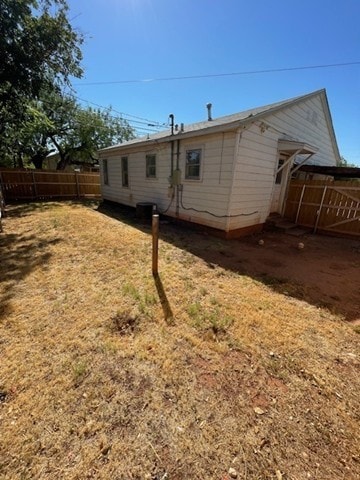 rear view of house with a yard