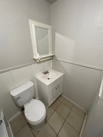 bathroom featuring vanity, tile patterned flooring, and toilet