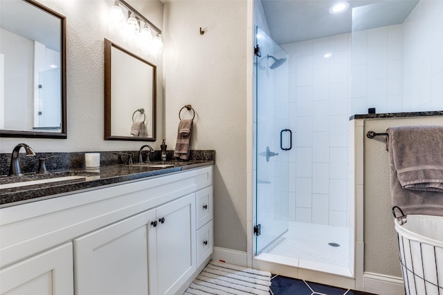 bathroom with vanity, tile patterned flooring, and a shower with door