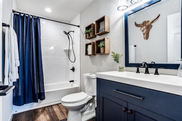 full bathroom featuring hardwood / wood-style flooring, vanity, shower / bath combination with curtain, and toilet