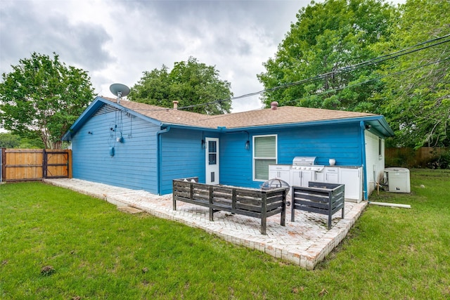 back of house with a patio and a yard