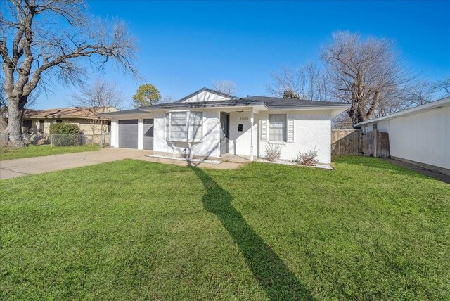 single story home featuring a garage and a front lawn