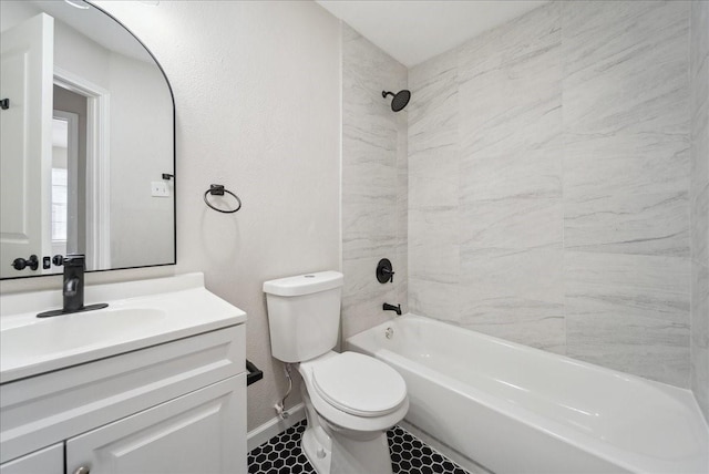 bathroom featuring baseboards, a textured wall, toilet, vanity, and washtub / shower combination