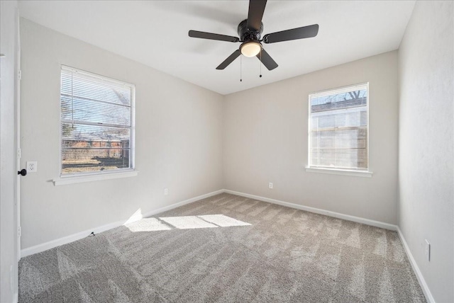 empty room featuring carpet floors, a ceiling fan, and baseboards