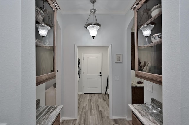 mudroom with light hardwood / wood-style flooring and ornamental molding